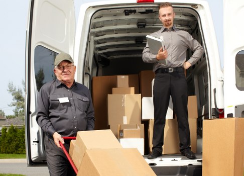 Removal team helping a Wimbledon home move with boxes and furniture