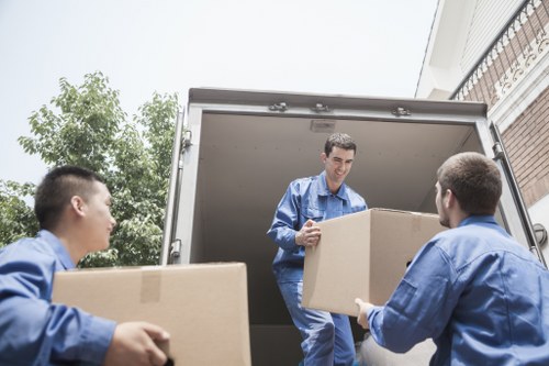 Careful loading of large furniture items for pickup in Wimbledon