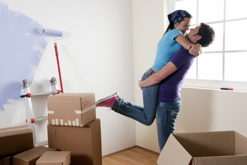 Professional movers handling household furniture carefully
