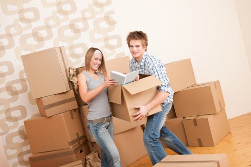 Movers carrying furniture from a Wimbledon home
